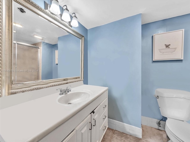 bathroom with toilet, a shower with door, vanity, and tile patterned flooring