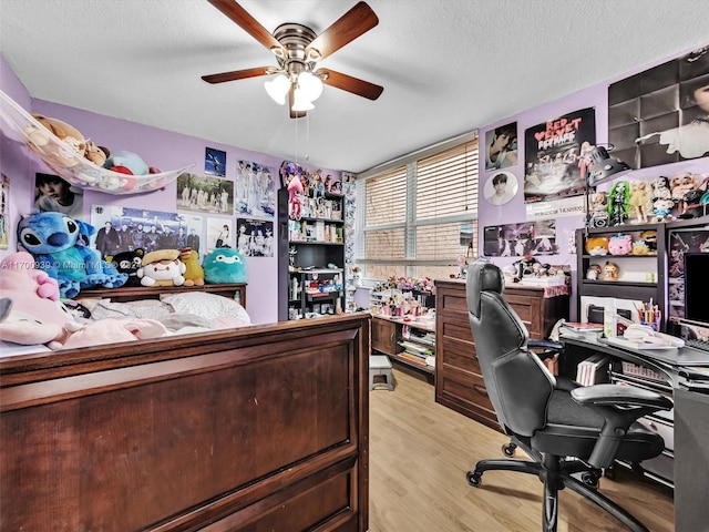 office with ceiling fan, light hardwood / wood-style floors, and a textured ceiling