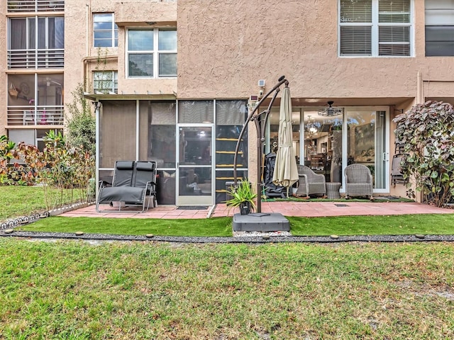 back of house with a yard and a patio