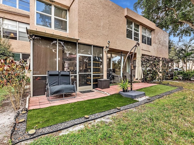 rear view of house with a patio area and a yard