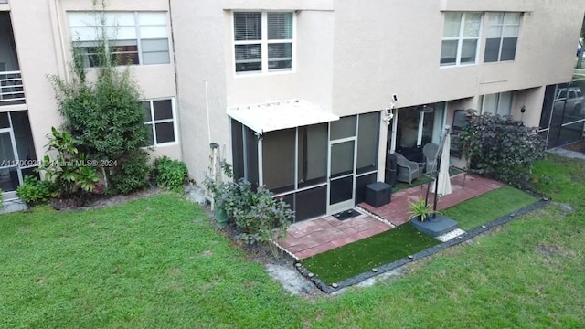 rear view of house with a patio area and a yard