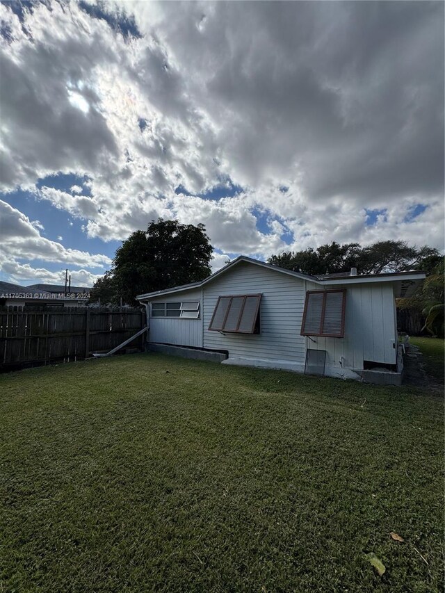 back of house with a yard