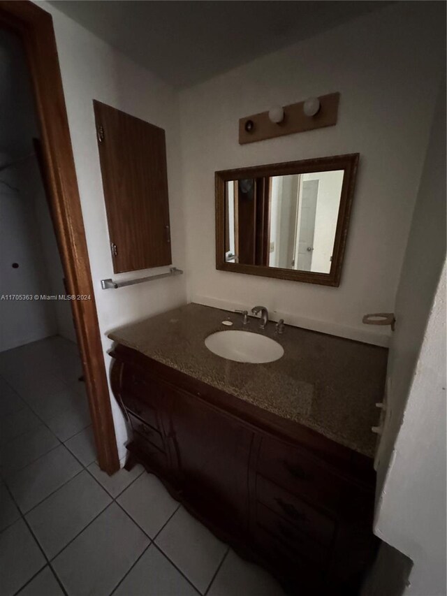 bathroom featuring tile patterned flooring and vanity