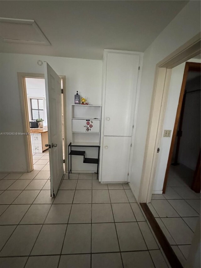 hallway with light tile patterned floors