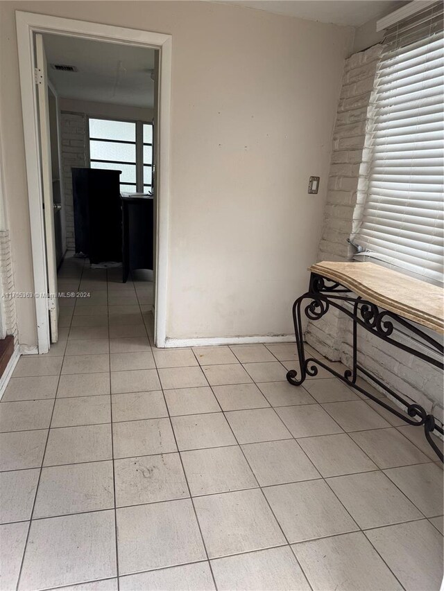 corridor featuring light tile patterned floors