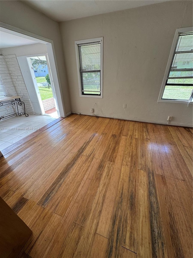 unfurnished room with a wealth of natural light and light hardwood / wood-style flooring