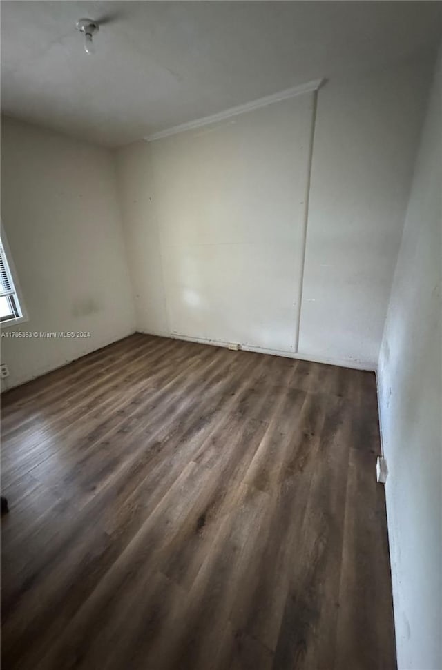 unfurnished room featuring dark hardwood / wood-style flooring