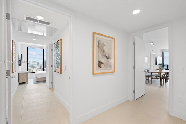 hall featuring light tile patterned floors