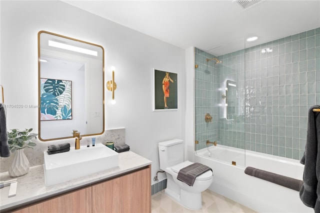 full bathroom with vanity, tiled shower / bath combo, and toilet