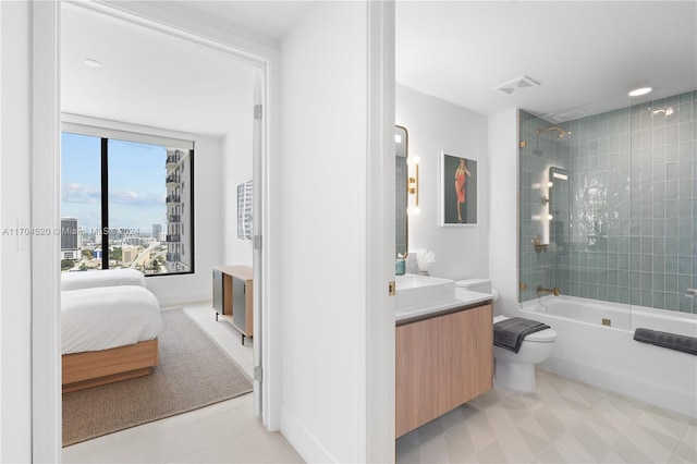 full bathroom with vanity, toilet, and tiled shower / bath