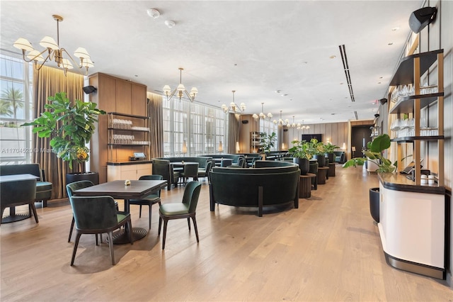 dining area with a chandelier and light wood-type flooring