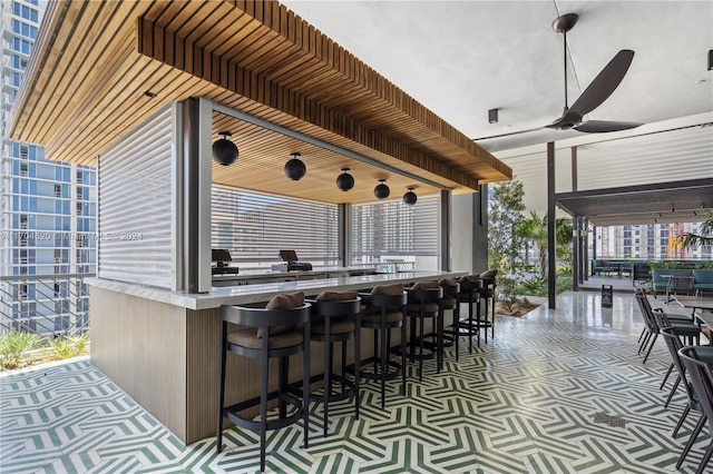 view of patio with ceiling fan and exterior bar