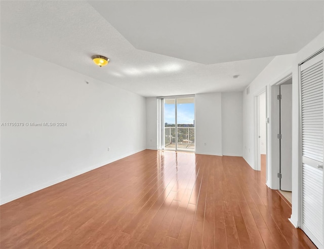 empty room featuring a textured ceiling and hardwood / wood-style flooring