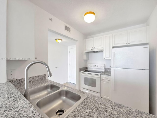 kitchen with white cabinetry, light stone counters, white appliances, and sink