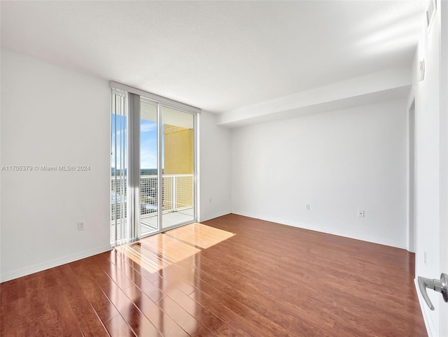 spare room featuring dark wood-type flooring