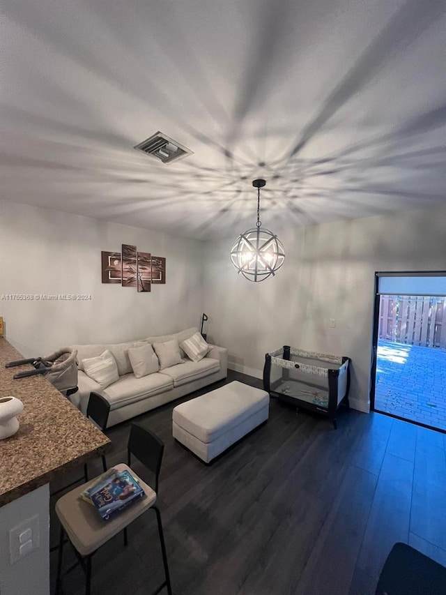 unfurnished living room featuring dark hardwood / wood-style flooring and a chandelier