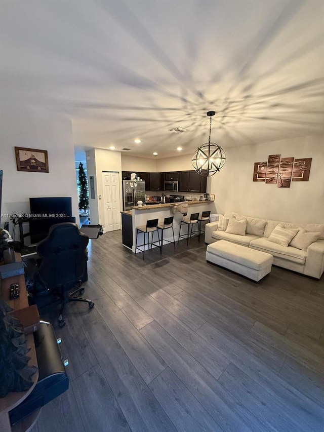 living room featuring a chandelier and dark hardwood / wood-style floors