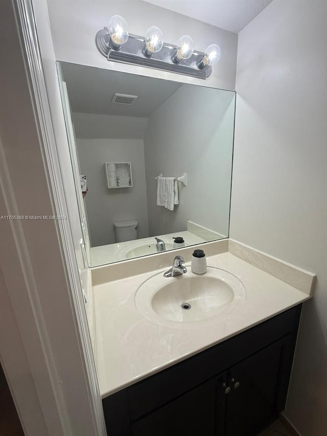 bathroom with vanity and toilet