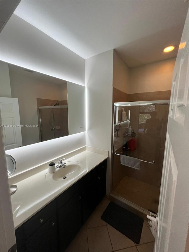 bathroom with vanity, tile patterned floors, and a shower with shower door