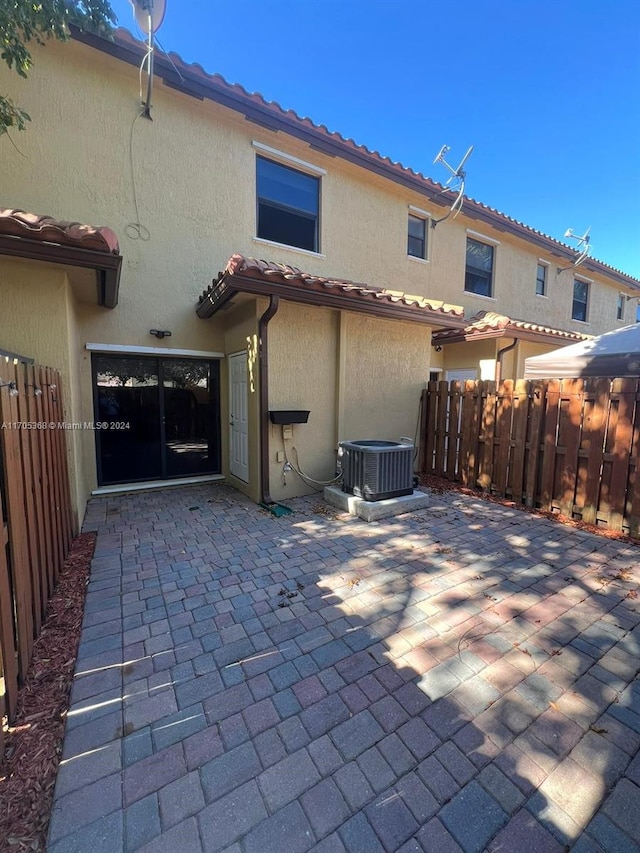 back of property featuring a patio area and cooling unit