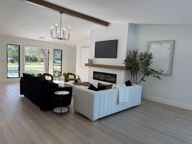 unfurnished living room with vaulted ceiling with beams, light wood-type flooring, and a notable chandelier