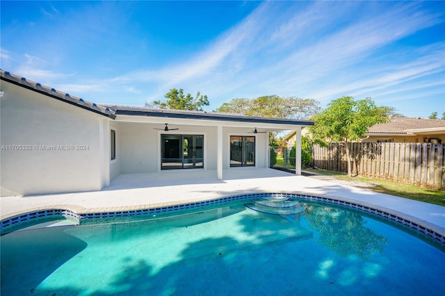 view of pool with ceiling fan and a patio