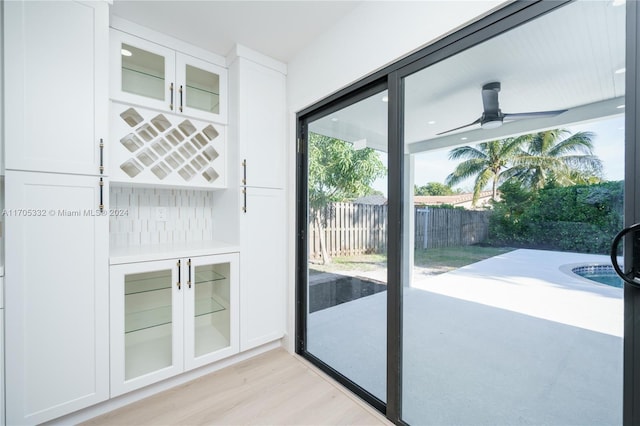 doorway to outside with ceiling fan and light hardwood / wood-style flooring