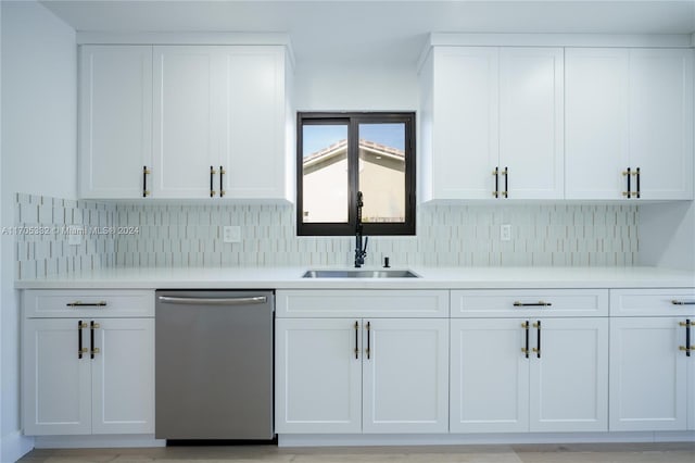 kitchen with white cabinetry, stainless steel dishwasher, and sink