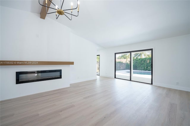 unfurnished living room featuring vaulted ceiling with beams and light hardwood / wood-style floors