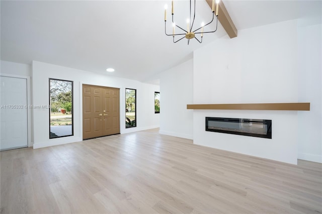 unfurnished living room with lofted ceiling with beams, light hardwood / wood-style floors, and an inviting chandelier