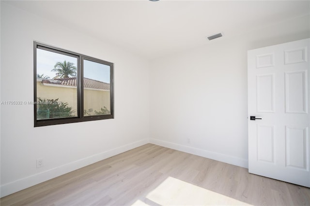 unfurnished room with light wood-type flooring