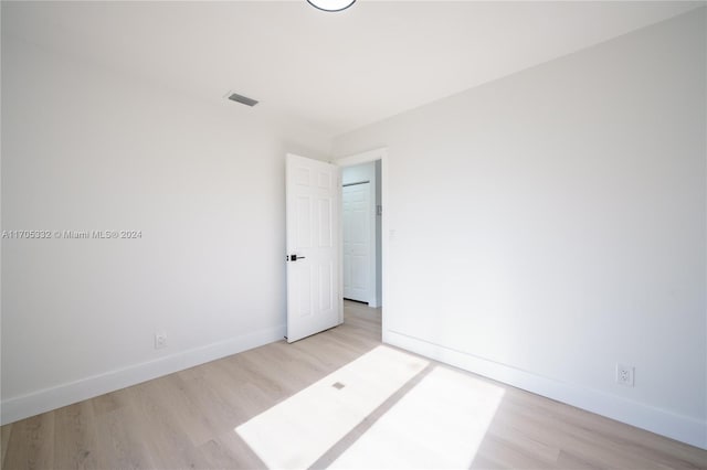 empty room with light hardwood / wood-style flooring