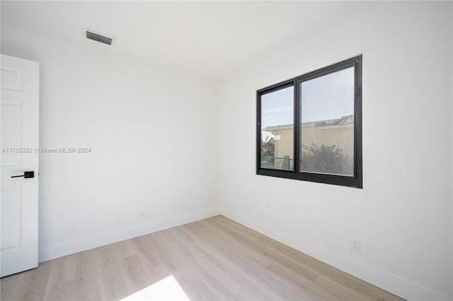 spare room featuring light hardwood / wood-style flooring