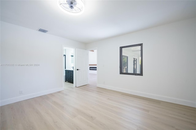 empty room with light wood-type flooring and ceiling fan