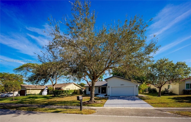 single story home with a garage and a front lawn