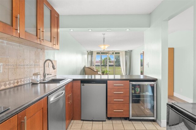 kitchen featuring sink, wine cooler, light tile patterned floors, tasteful backsplash, and stainless steel appliances