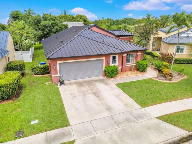 view of front of home featuring a front yard and a garage