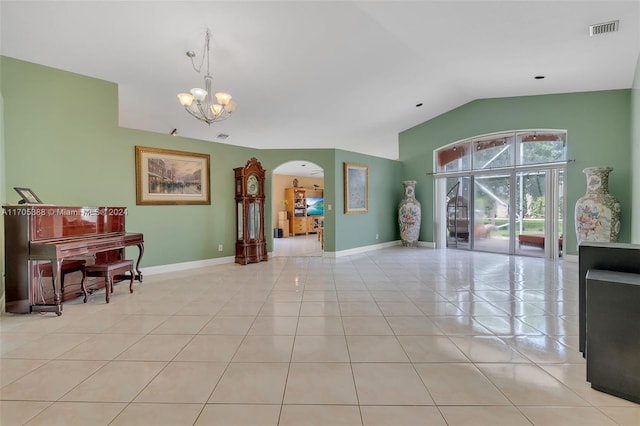 tiled dining area with a notable chandelier and vaulted ceiling