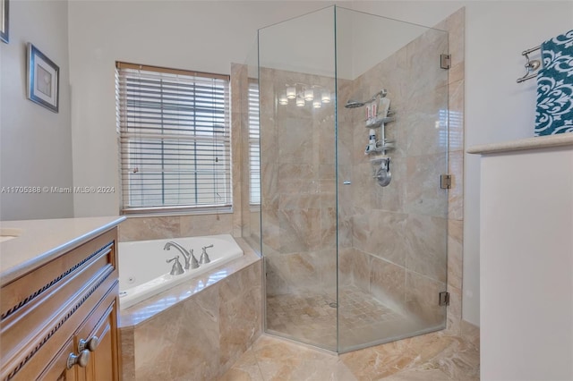 bathroom with vanity and shower with separate bathtub