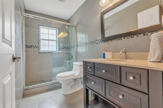 bathroom featuring vanity, tile patterned floors, toilet, tile walls, and an enclosed shower