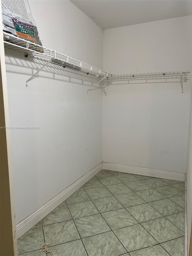 walk in closet featuring tile patterned flooring