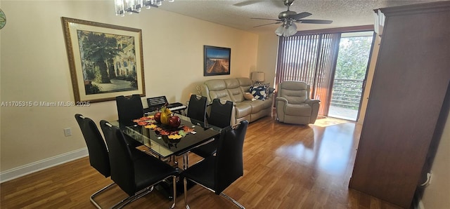 dining area featuring a ceiling fan, baseboards, a textured ceiling, and wood finished floors