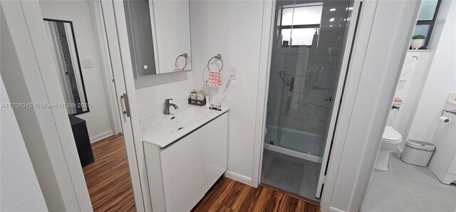 bathroom with toilet and an enclosed shower