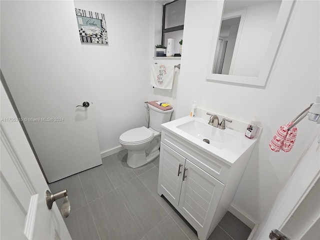 bathroom with tile patterned floors, vanity, and toilet