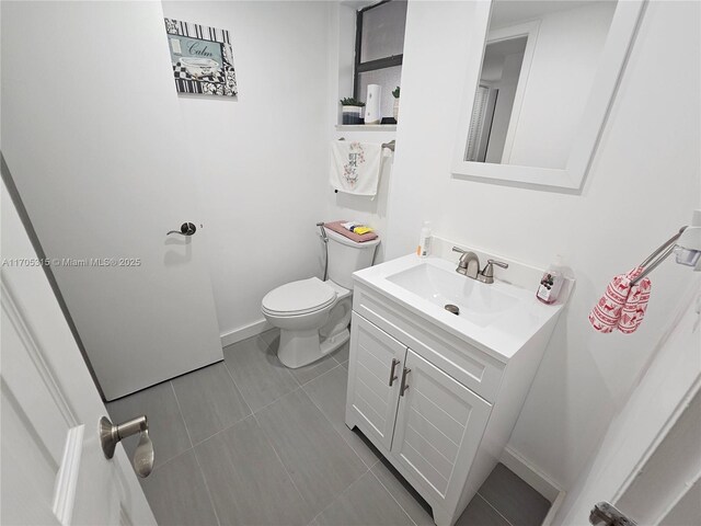 laundry room featuring stacked washer / dryer and light tile patterned floors