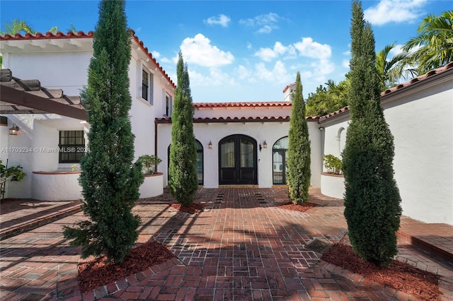 view of front facade with a patio and french doors