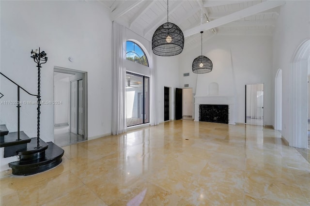 unfurnished living room featuring beam ceiling, wood ceiling, a fireplace, and high vaulted ceiling