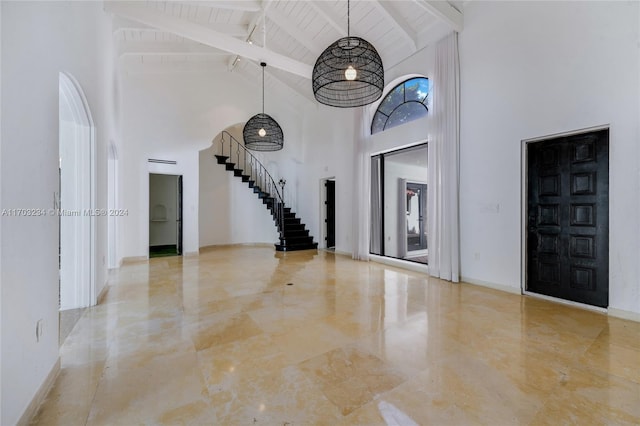 entryway with beam ceiling, high vaulted ceiling, and wood ceiling