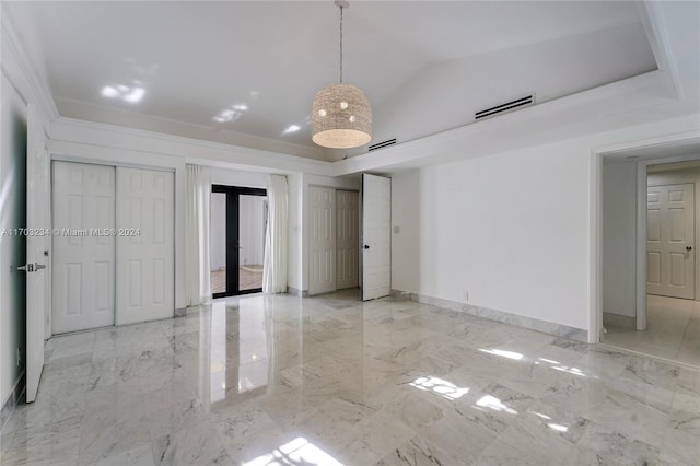 unfurnished bedroom featuring ornamental molding, french doors, and vaulted ceiling