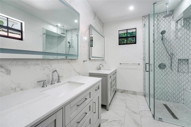 bathroom with an enclosed shower, vanity, and a wealth of natural light